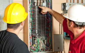 Electricians identify a 20 amp breaker that has gone bad and replace it.