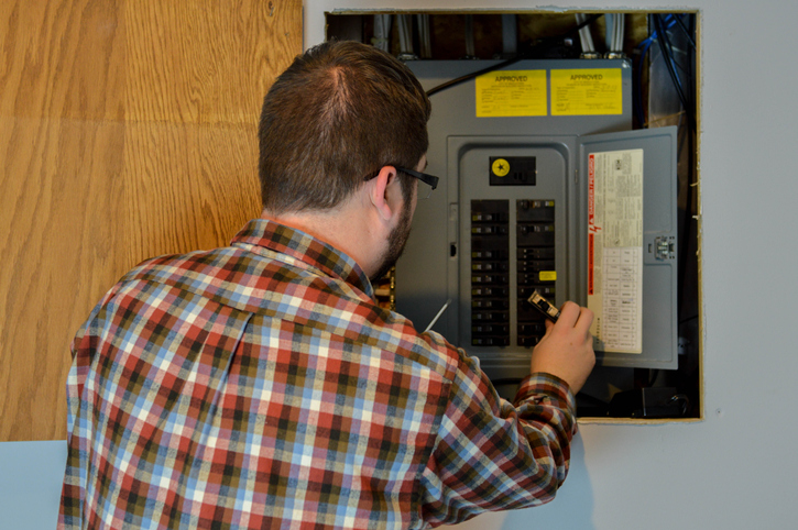 repairman inspecting an electric box